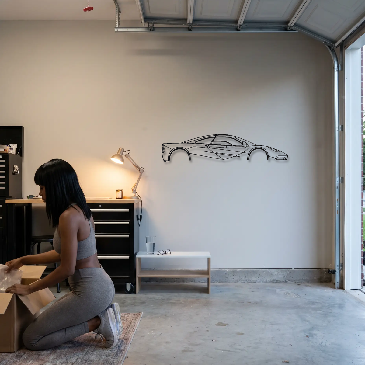 McLaren F1 metal wall art shown to scale beside a person