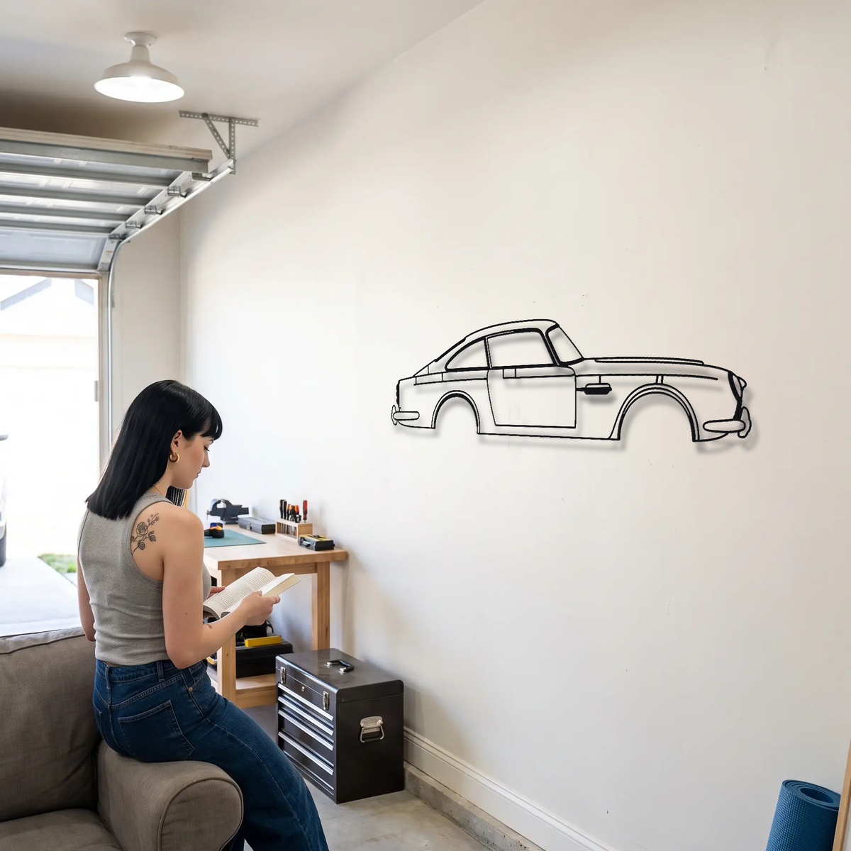 Aston Martin DB5 metal wall art shown to scale beside a person