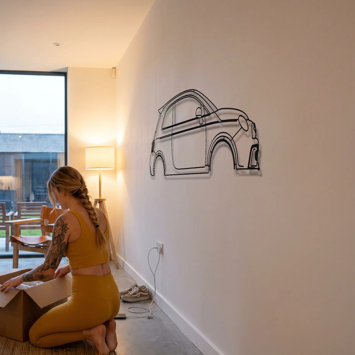 Fiat 500 Abarth metal wall art shown to scale beside a person