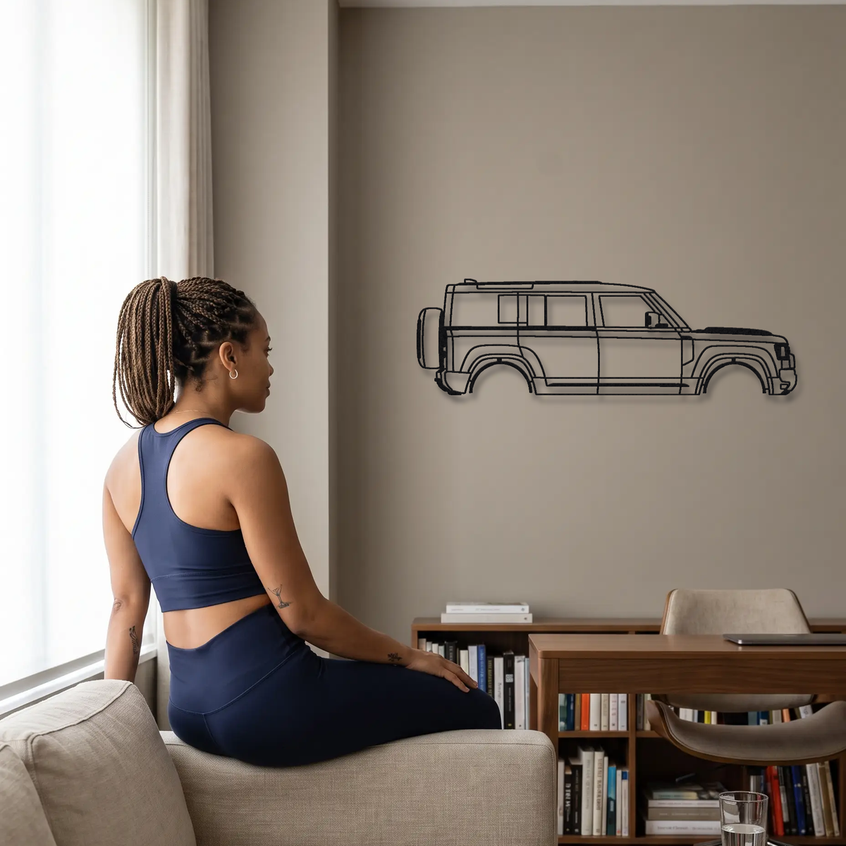 2025- Land Rover Defender OCTA L663 metal wall art shown to scale beside a person