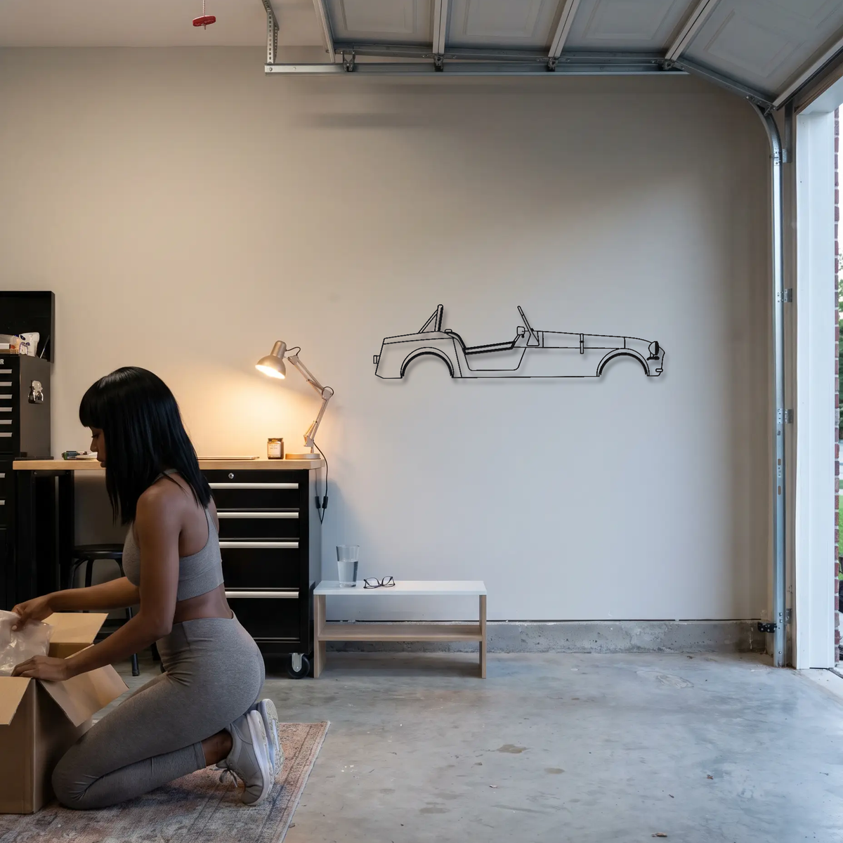 Caterham Seven 170 metal wall art shown to scale beside a person