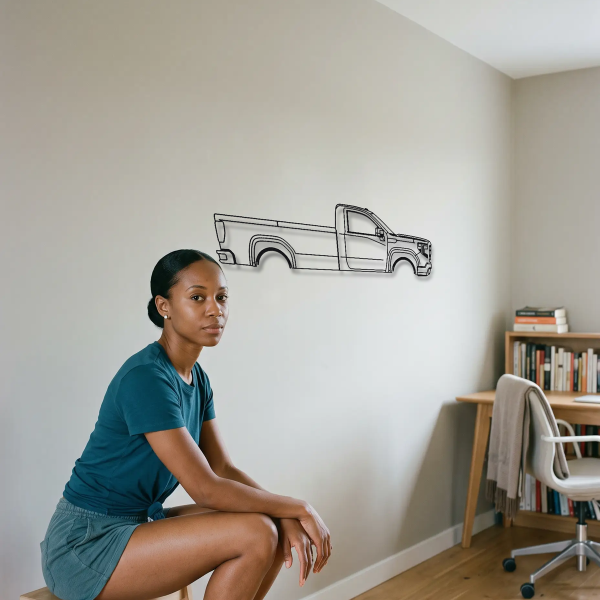 GMC Sierra T1XX metal wall art shown to scale beside a person