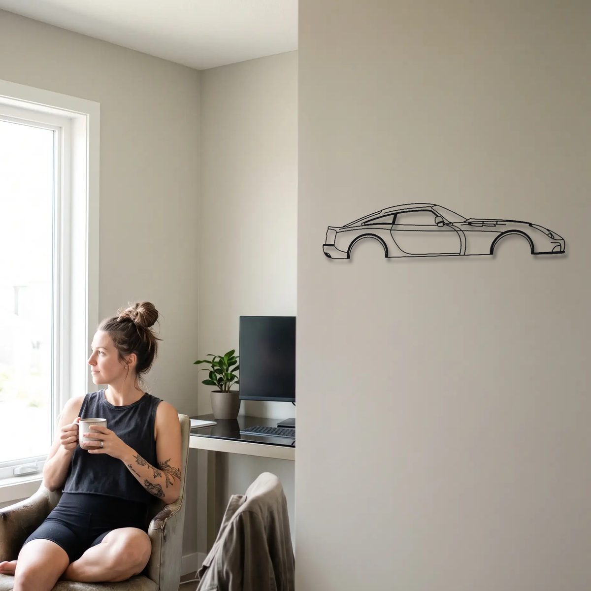 TVR Sagaris metal wall art shown to scale beside a person