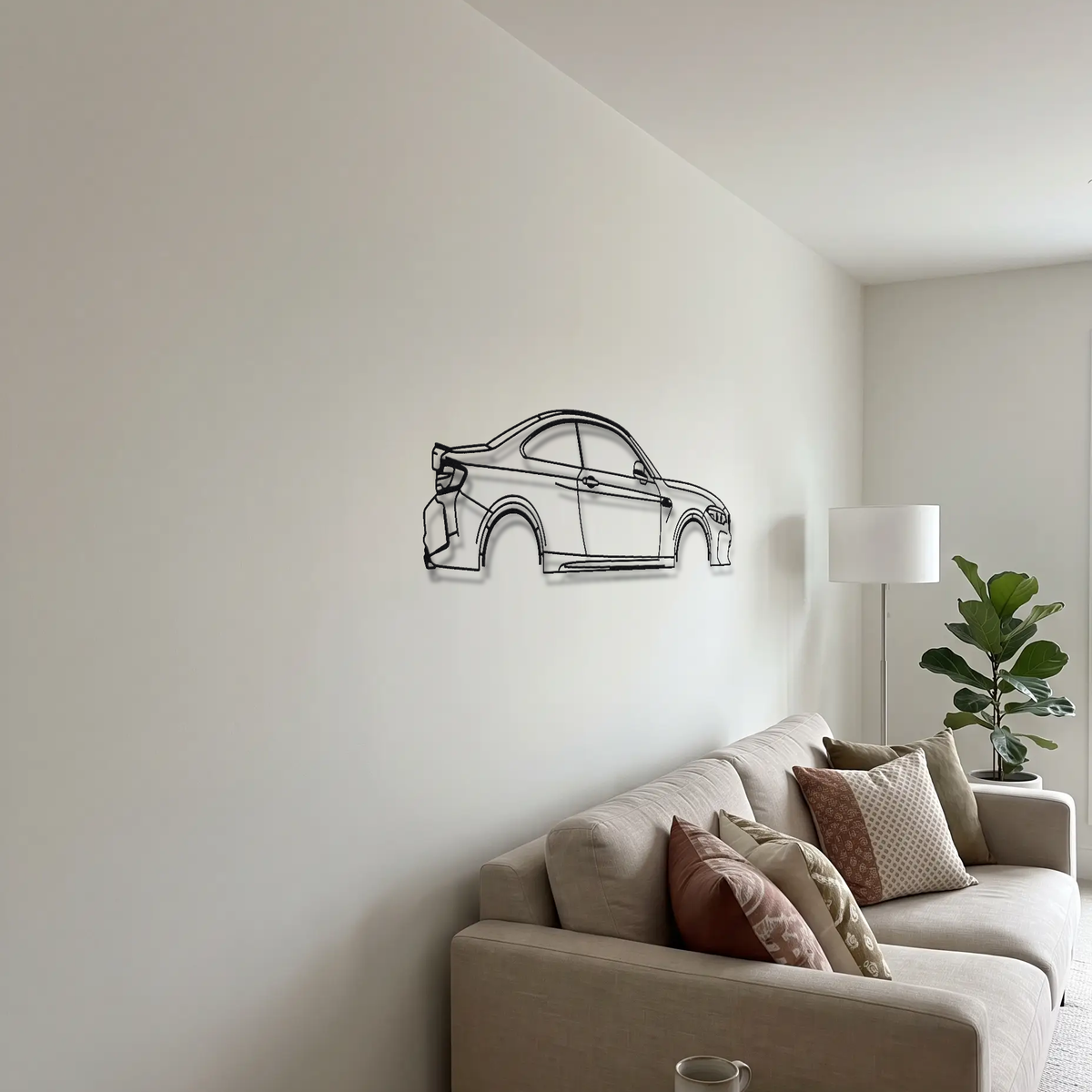BMW M2 F87 metal wall art above a sofa in a living room
