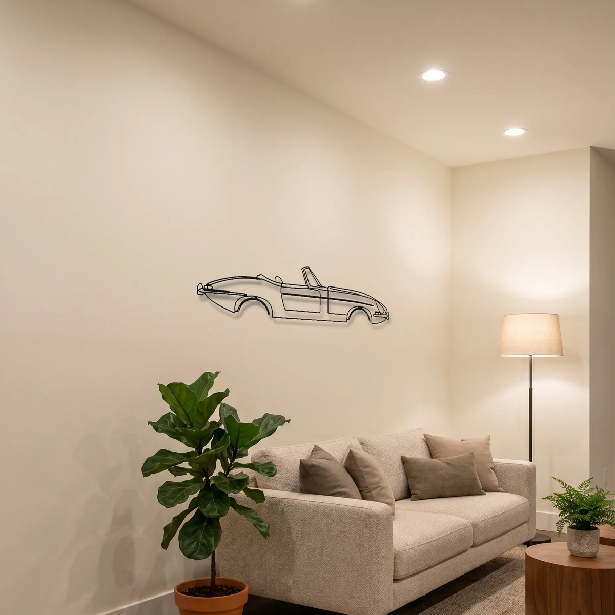 Jaguar E-Type Series 1 Roadster metal wall art above a sofa in a living room