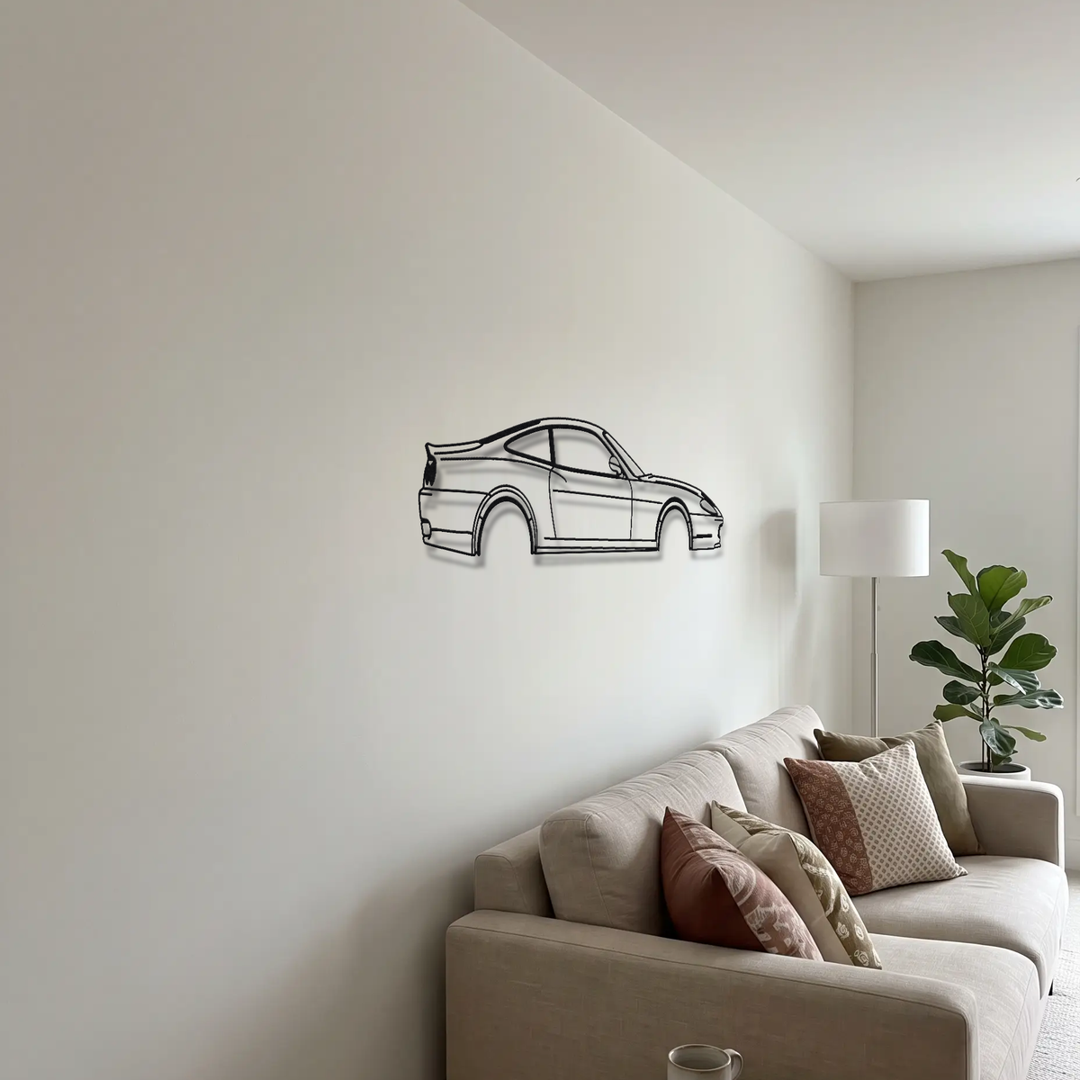 Ferrari 575M Maranello metal wall art above a sofa in a living room