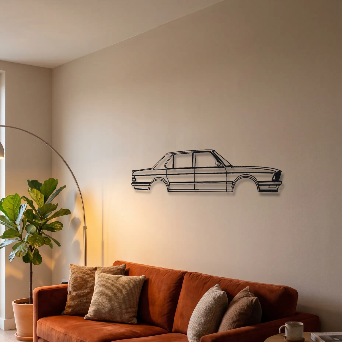 BMW M5 E28 metal wall art above a sofa in a living room