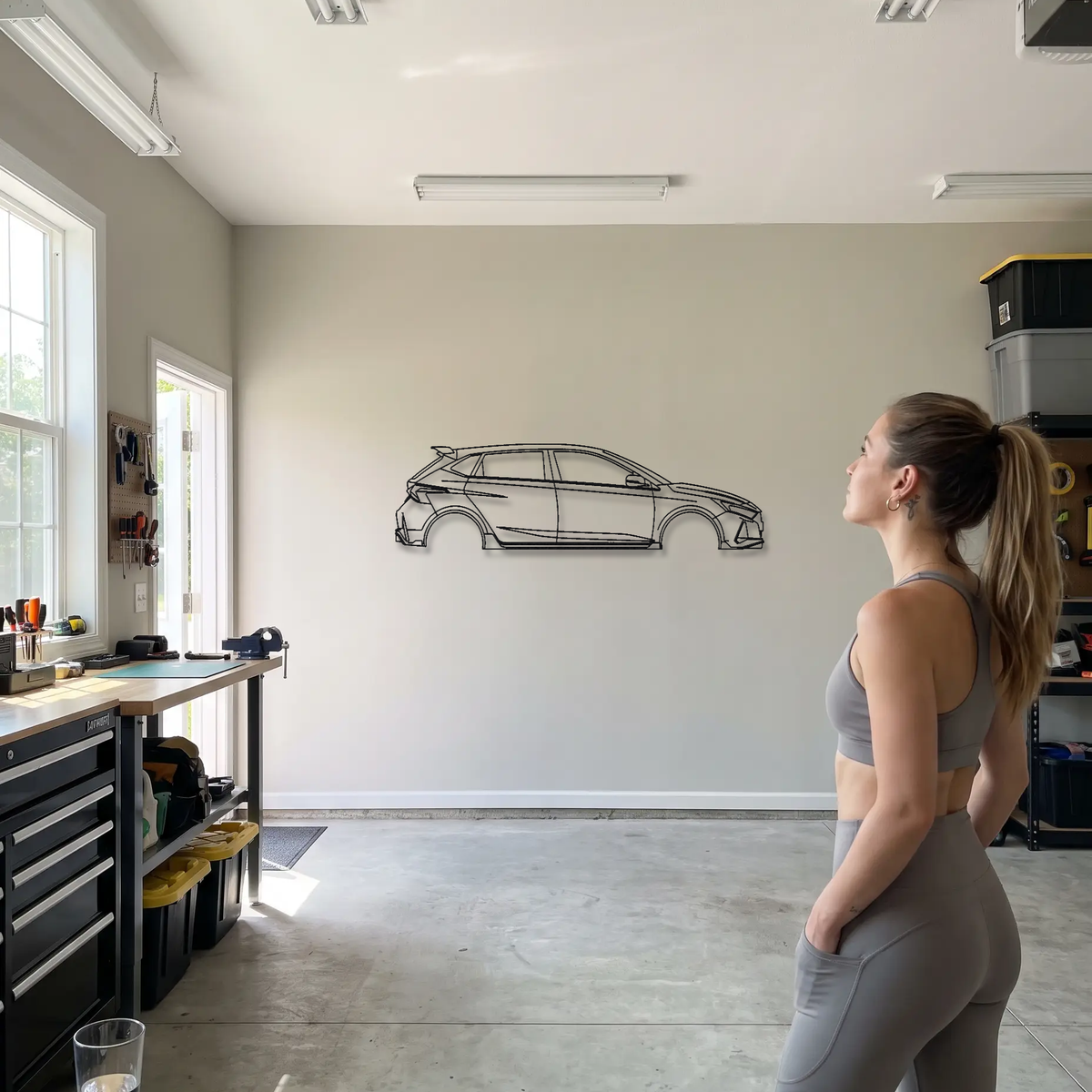 Hyundai i20 N metal wall art shown to scale beside a person