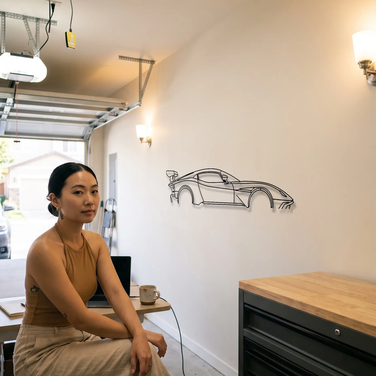 Aston Martin Vulcan metal wall art shown to scale beside a person