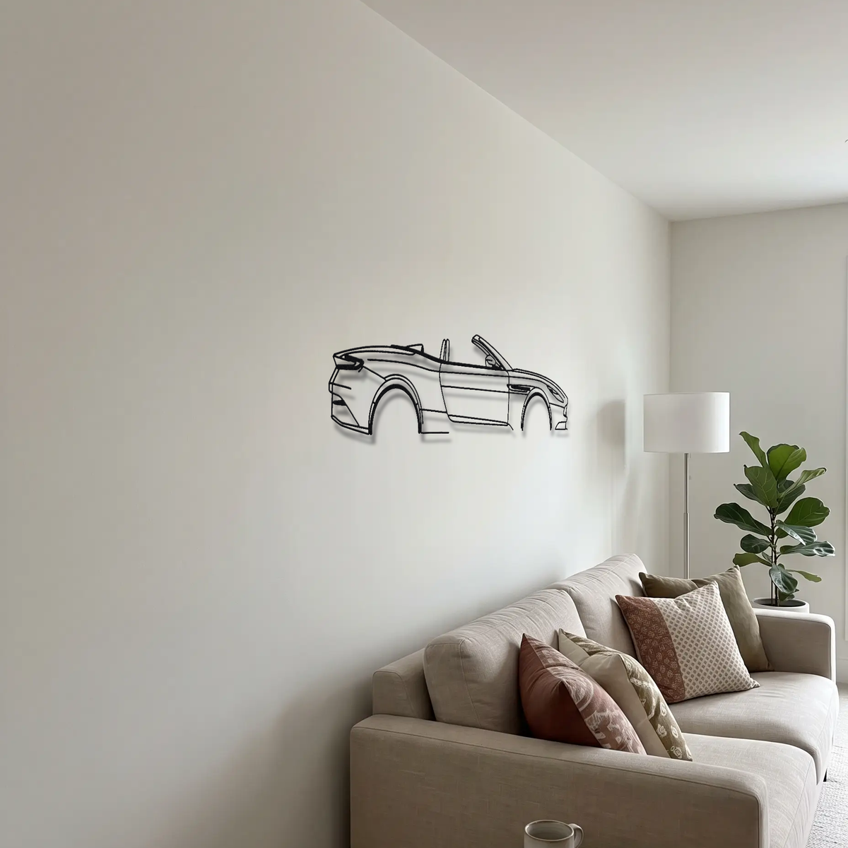 Aston Martin DB11 Volante metal wall art above a sofa in a living room