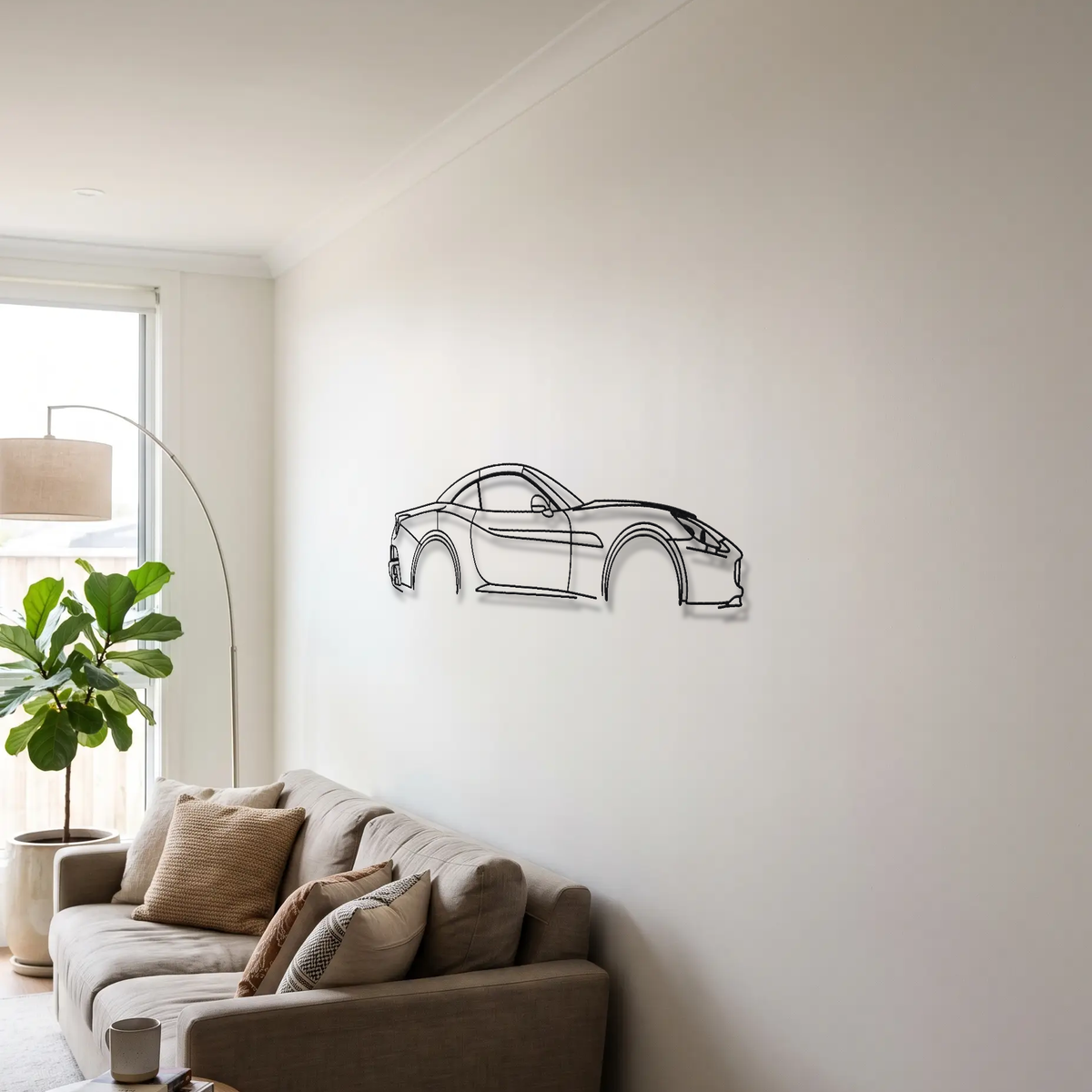 Ferrari California metal wall art above a sofa in a living room